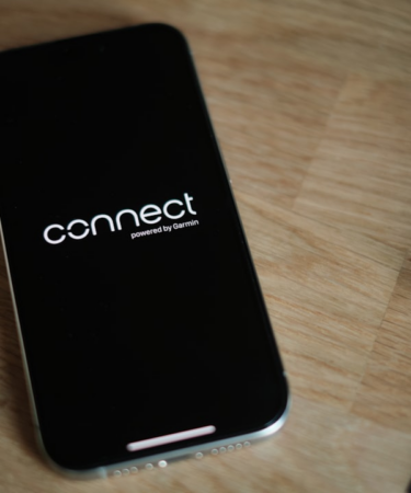 A cell phone sitting on top of a wooden table — Foto por appshunter.io na Unsplash