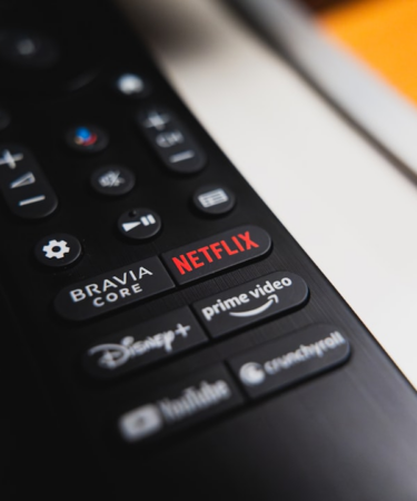 Black remote control showing netflix, prime video, and disney+ buttons. — Foto por Anthony Gomez na Unsplash