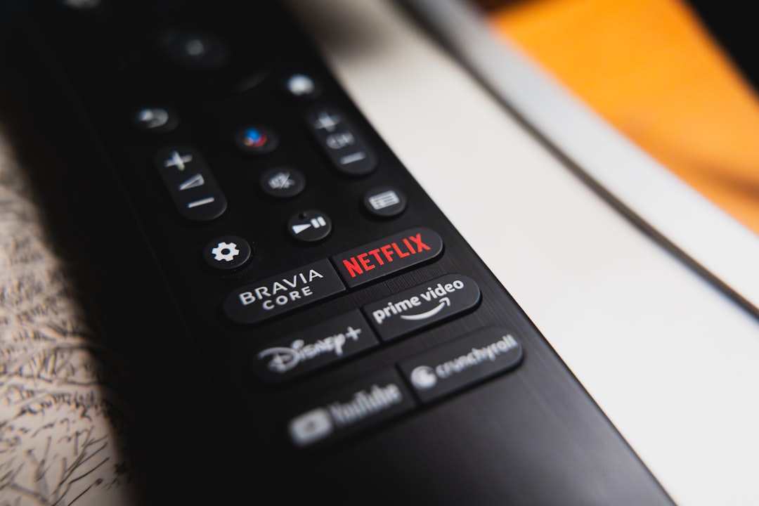 Black remote control showing netflix, prime video, and disney+ buttons. — Foto por Anthony Gomez na Unsplash
