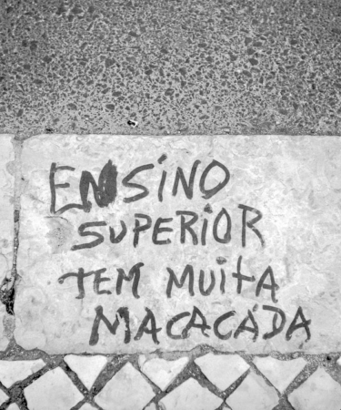a cement wall with graffiti written on it — Foto por Manuel Palmeira na Unsplash