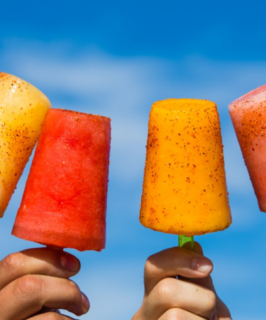person holding orange ice pop — Foto por Jarritos Mexican Soda na Unsplash