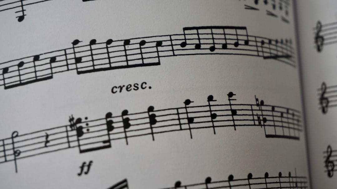 a close up of a book with musical notes — Foto por Karen Chew na Unsplash